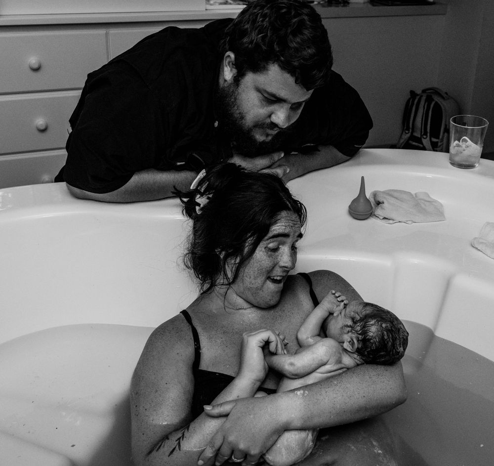 Black and white photo capturing first moments after water birth.