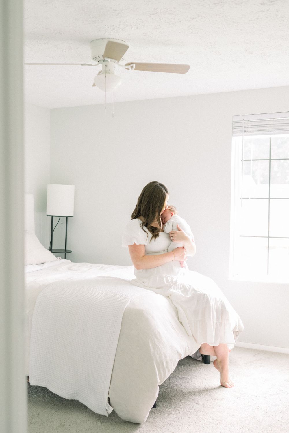 image of mom holding her baby  photographed by a Northern Virginia Newborn Photographer