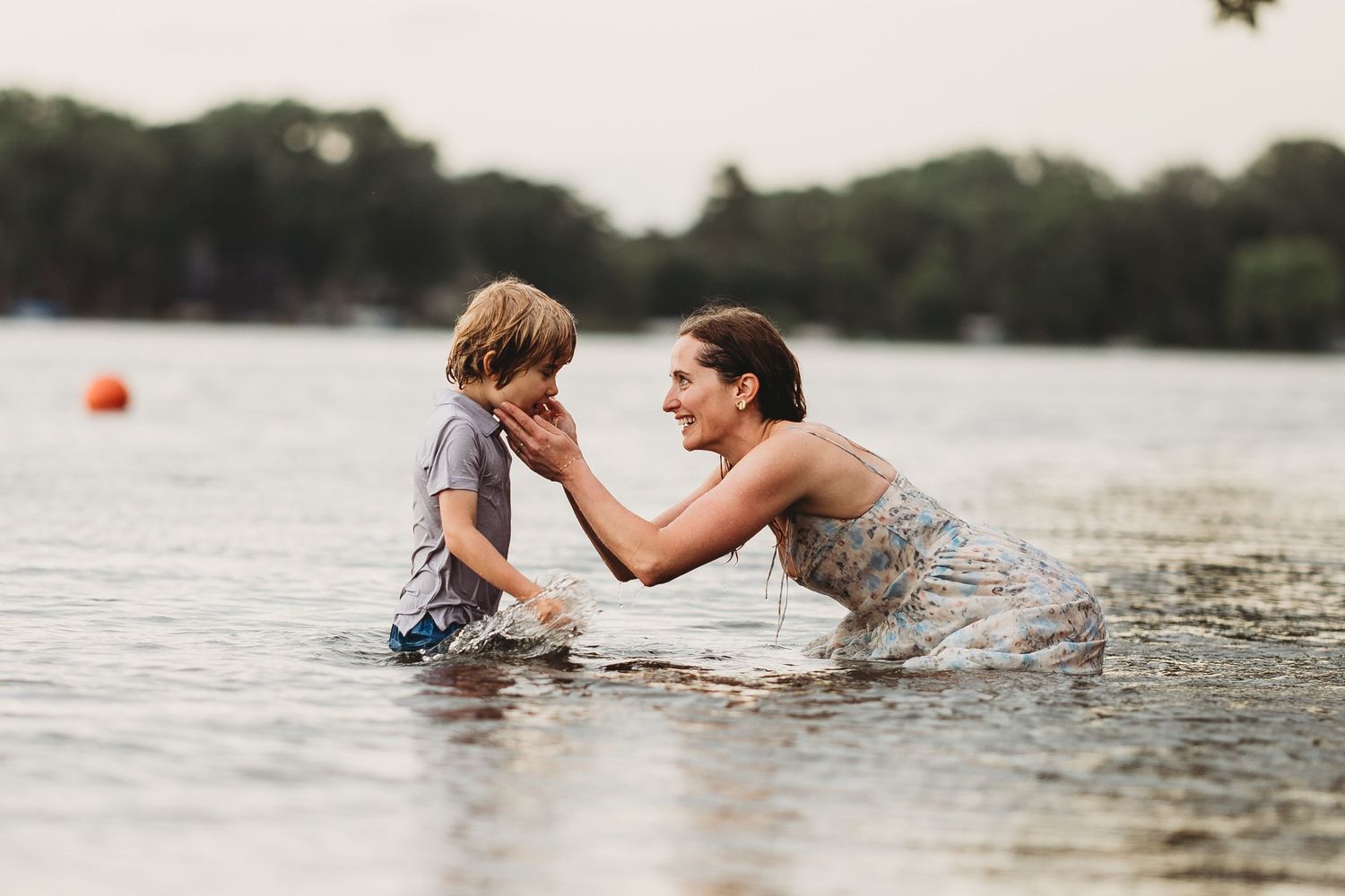 People playfully interact in the water during a warm summer day at the lake.