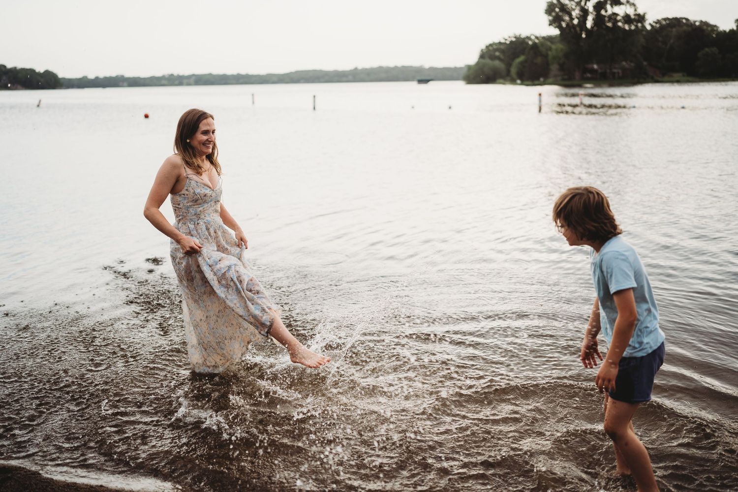 People enjoying a playful moment splashing in the lake water.