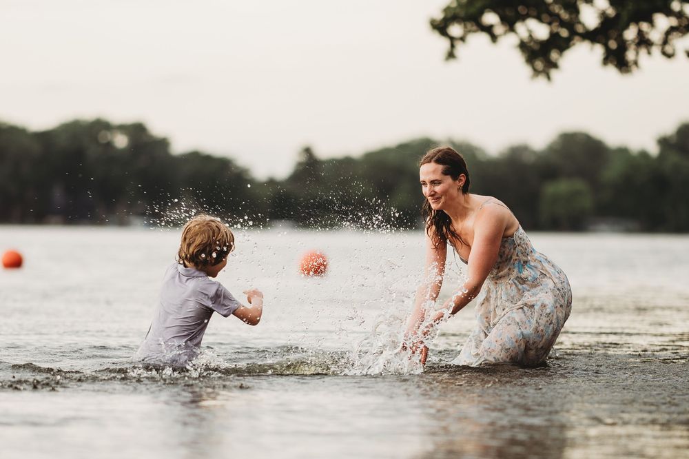 People playing and splashing in a lake during a fun summer activity.