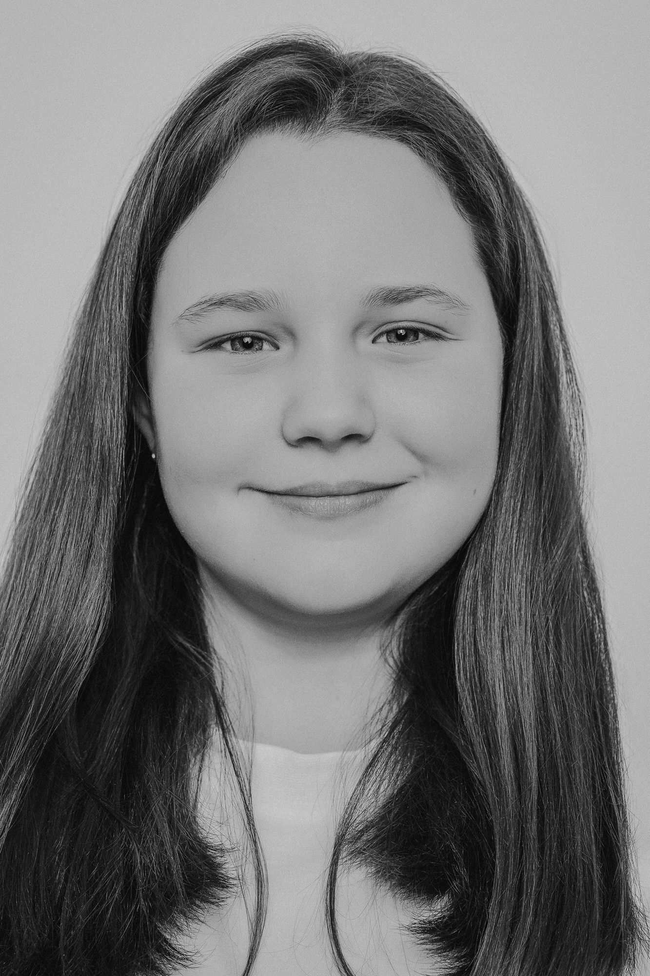 Black and white portrait series showing progressive smiles from subtle to full expression.