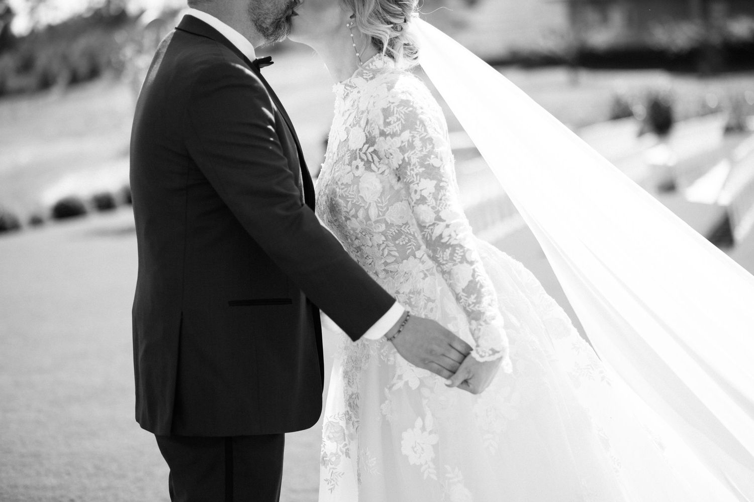 Black and white wedding photo showing intricate lace veil detail.