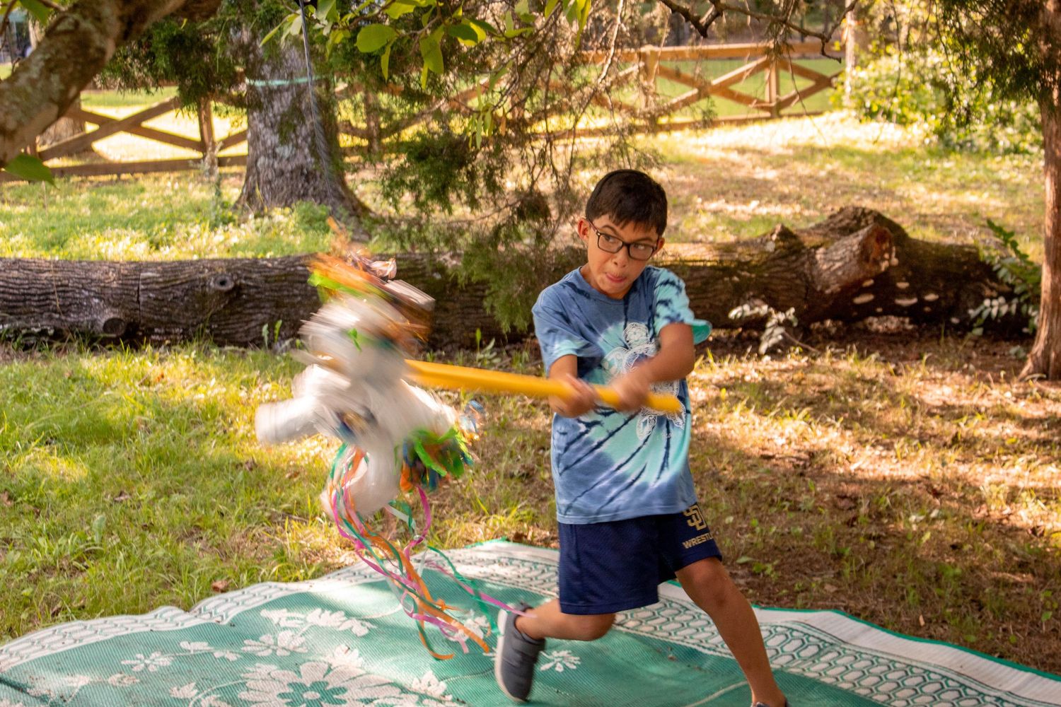 Young boy hitting a piñata at a birthday party photographed by a Chattanooga family photographer