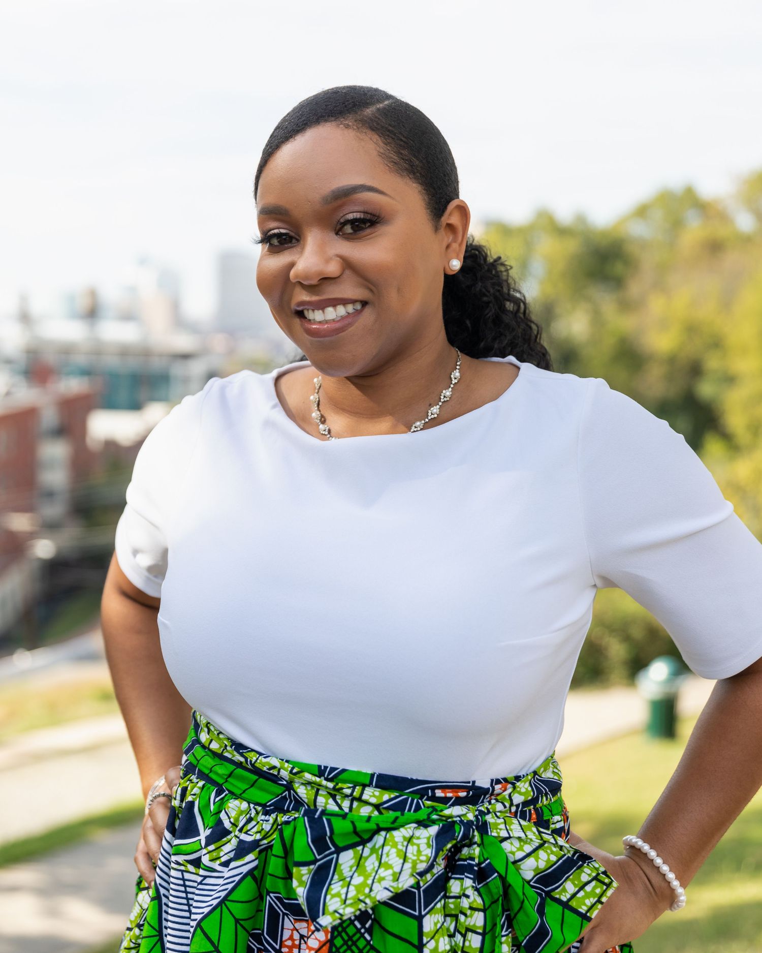 Professional headshots showing a woman in a white striped shirt against a natural outdoor background.