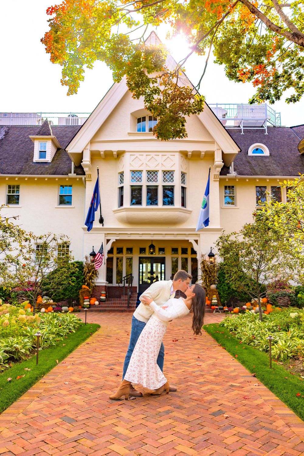 A romantic dance sequence on a brick patio in front of a charming white cottage with autumn leaves overhead.