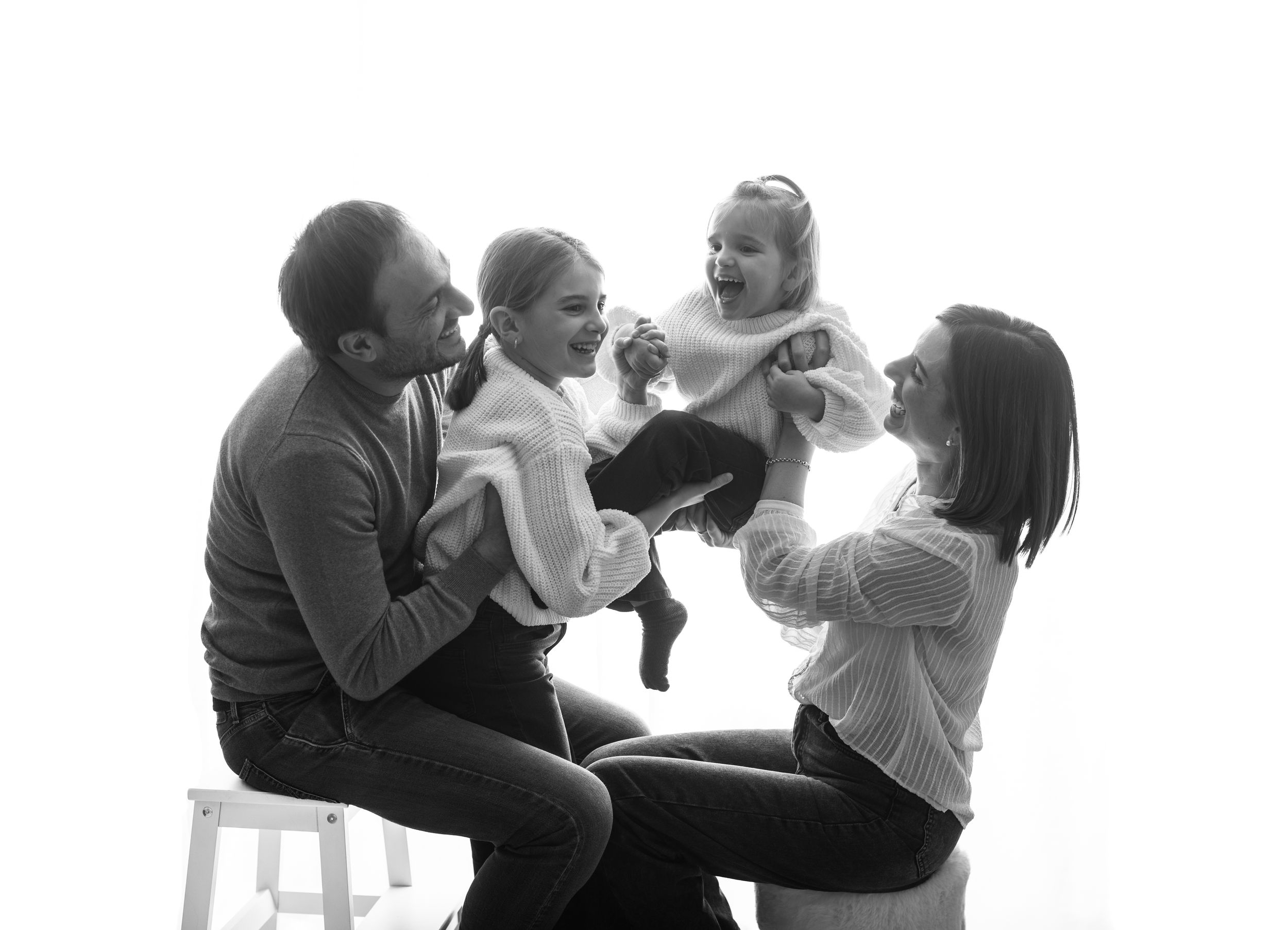 A black and white photo sequence shows a parent feeding a baby in a high chair, capturing tender mealtime moments.