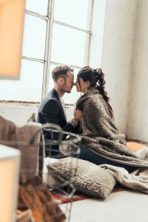 a photo of a beautiful couple during a love shoot in an urban industrial environment