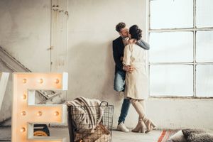 a photo of a beautiful couple during a love shoot in an urban industrial environment