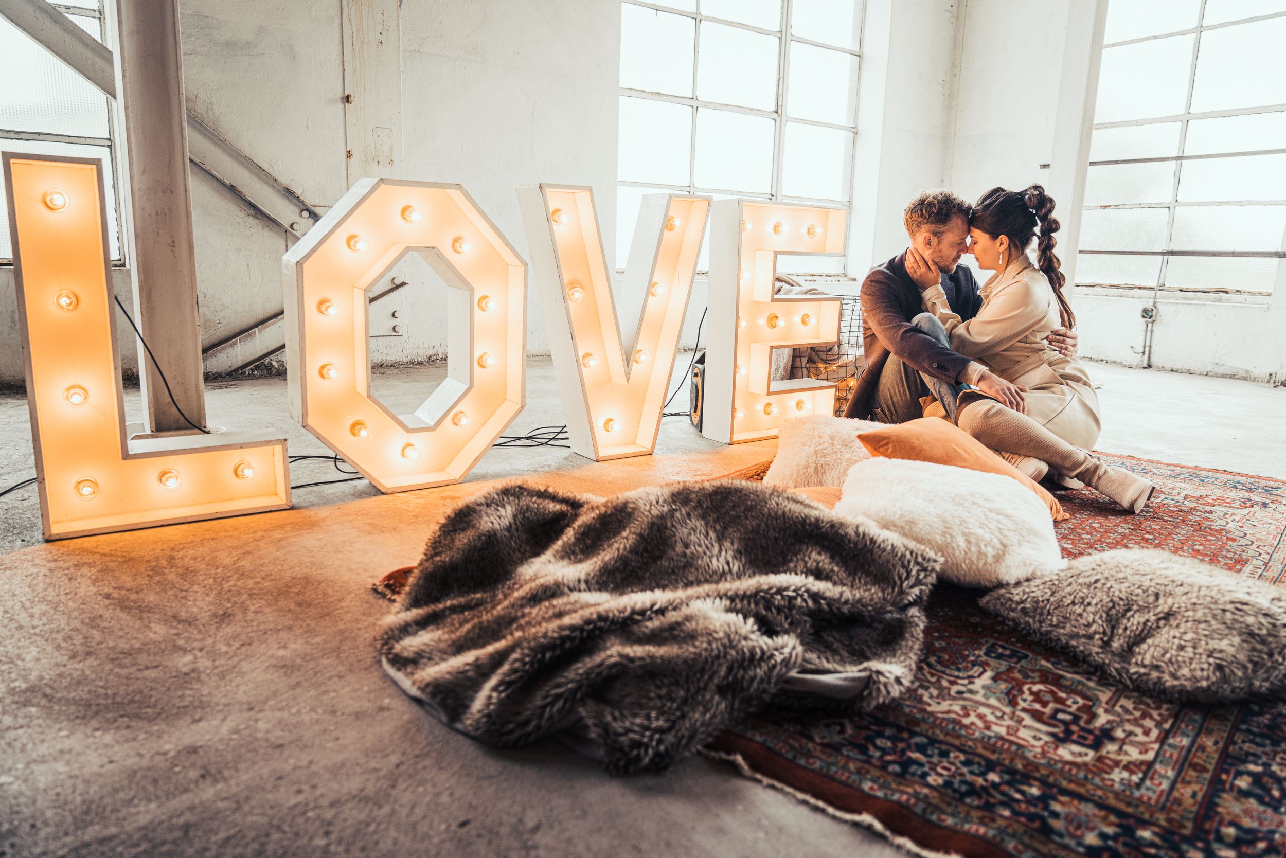 a photo of a beautiful couple during a love shoot in an urban industrial environment