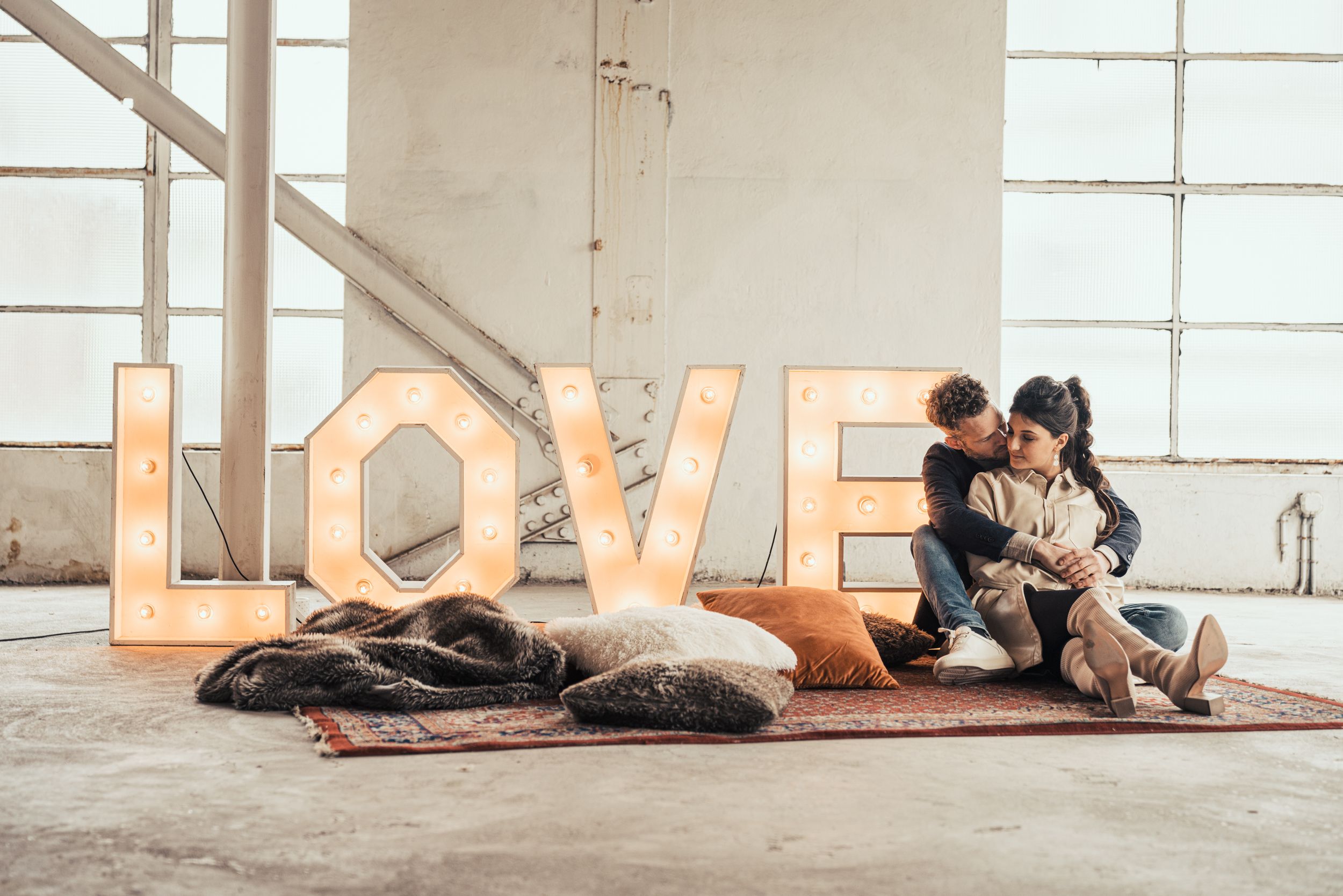 a photo of a beautiful couple during a love shoot in an urban industrial environment