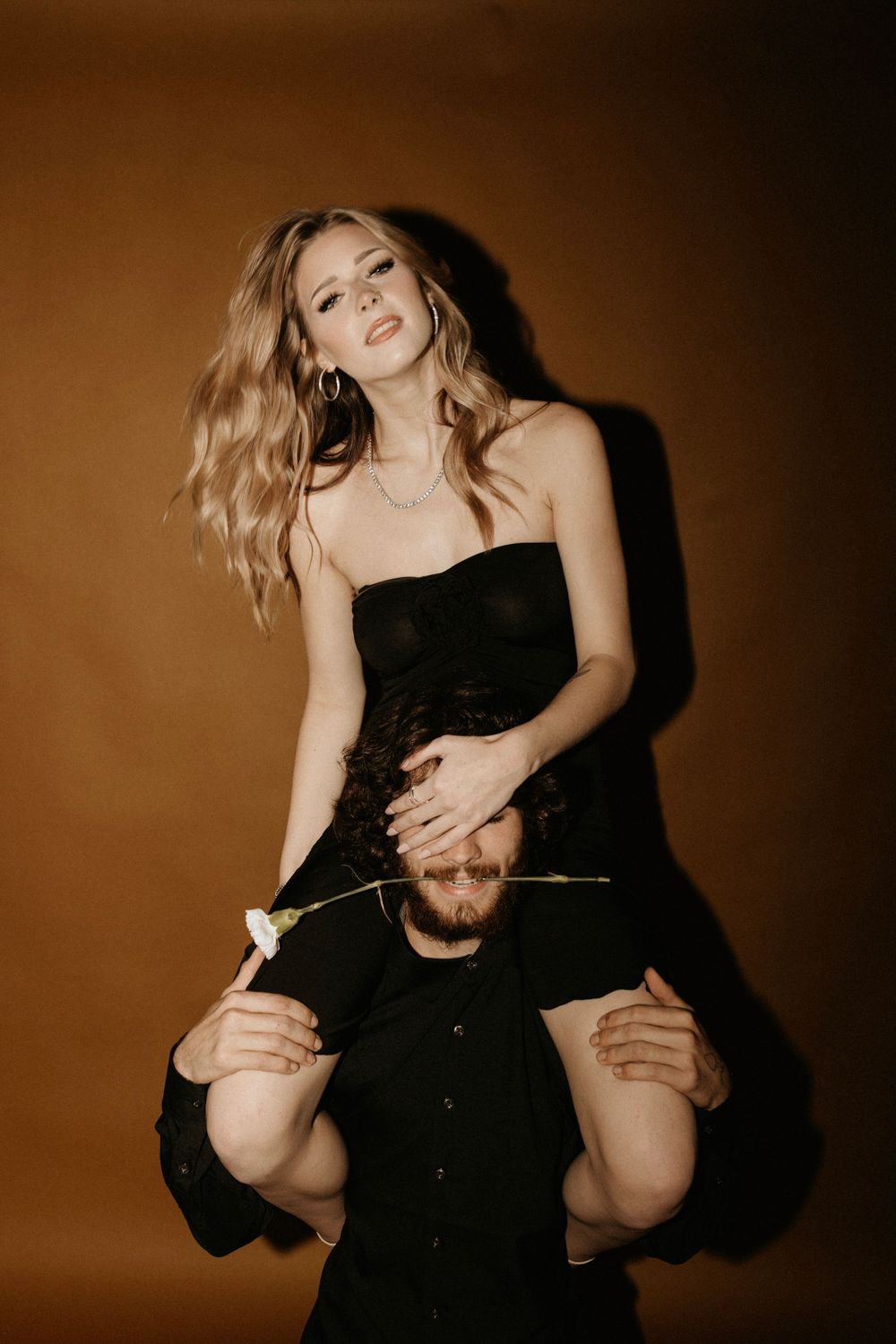 Creative fashion shoot with playful poses and contrasting black and white styling.