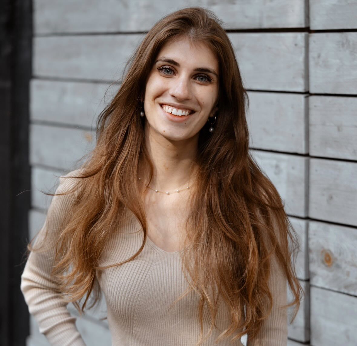 Portrait series showing joyful expressions and movement against an industrial backdrop.