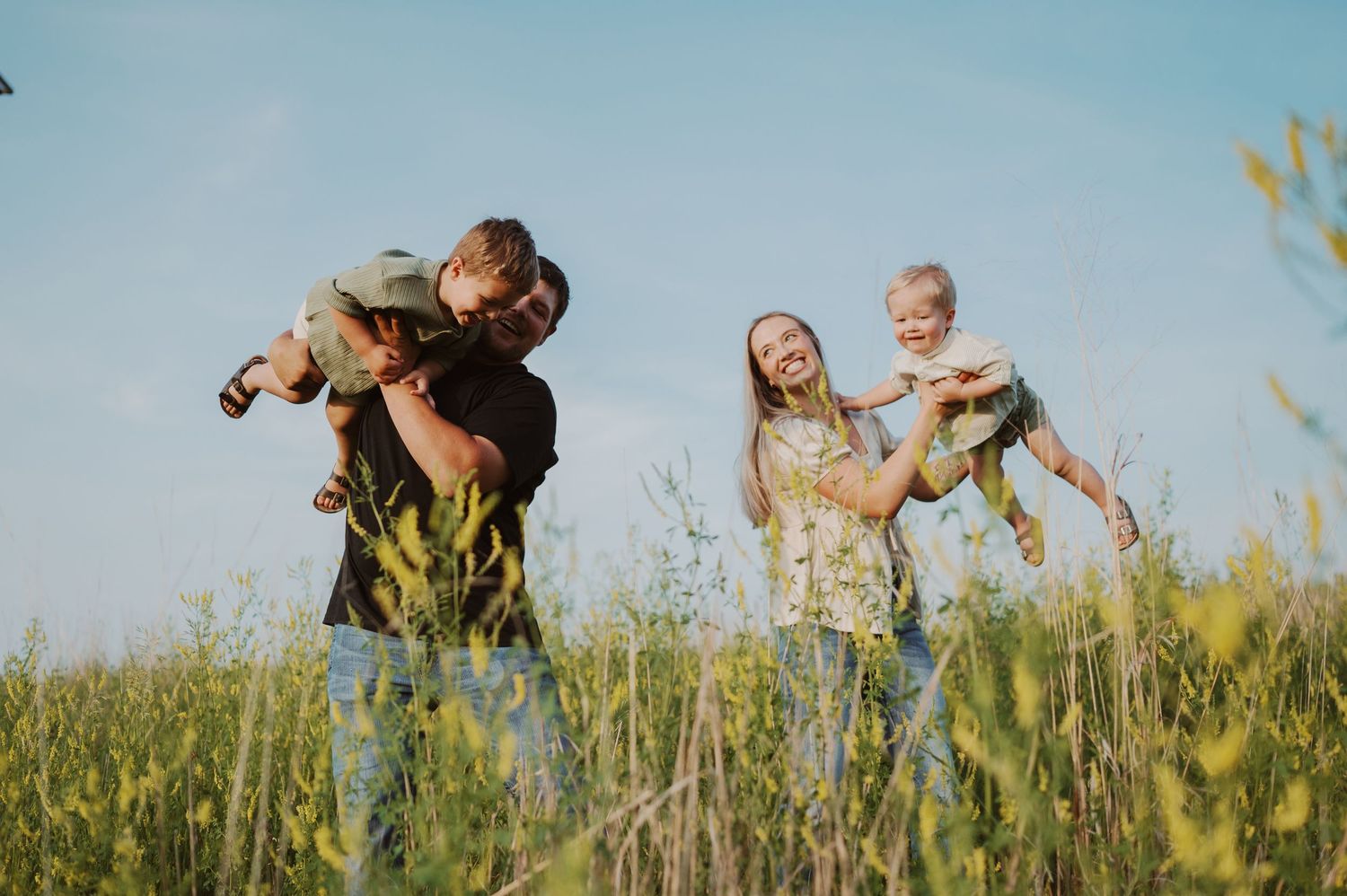 Family members walk together during golden hour in a fall outdoor setting.