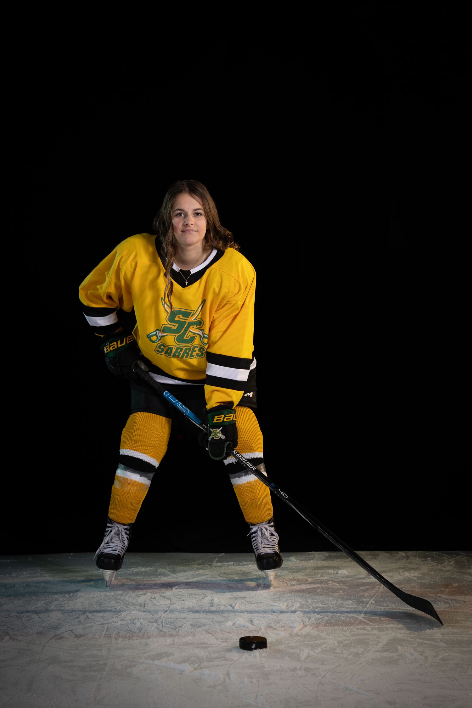 Stoney Creek Sabres Girls hockey player posing for during on ice portrait session in Stoney Creek