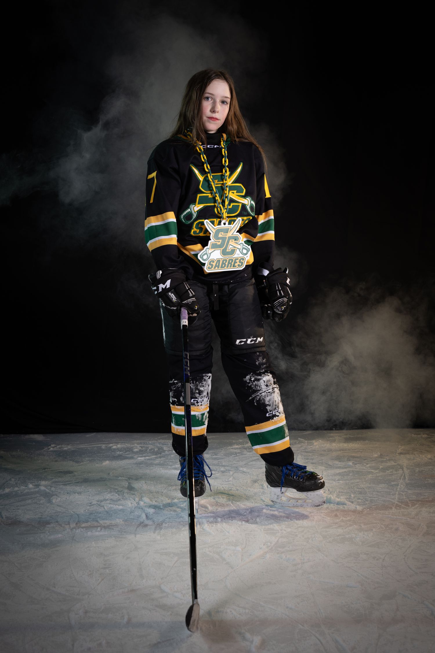 Stoney Creek Sabres Girls hockey player posing during on ice portrait session in Stoney Creek