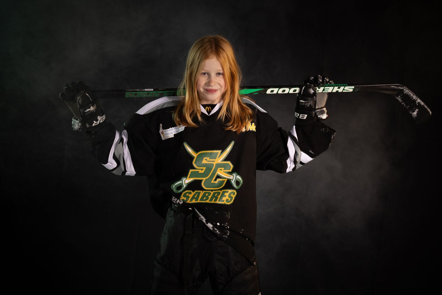 Stoney Creek Sabres Girls hockey player posing during on ice portrait session in Stoney Creek