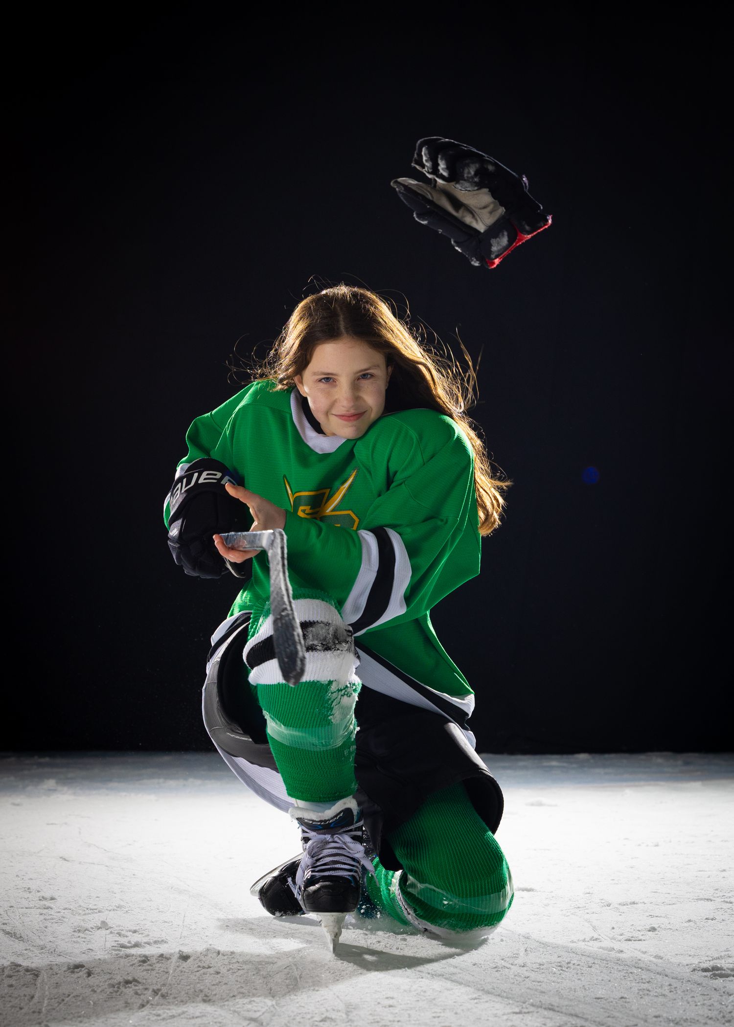 Stoney Creek Sabres Girls hockey player posing for a celly during on ice portrait session in Stoney Creek