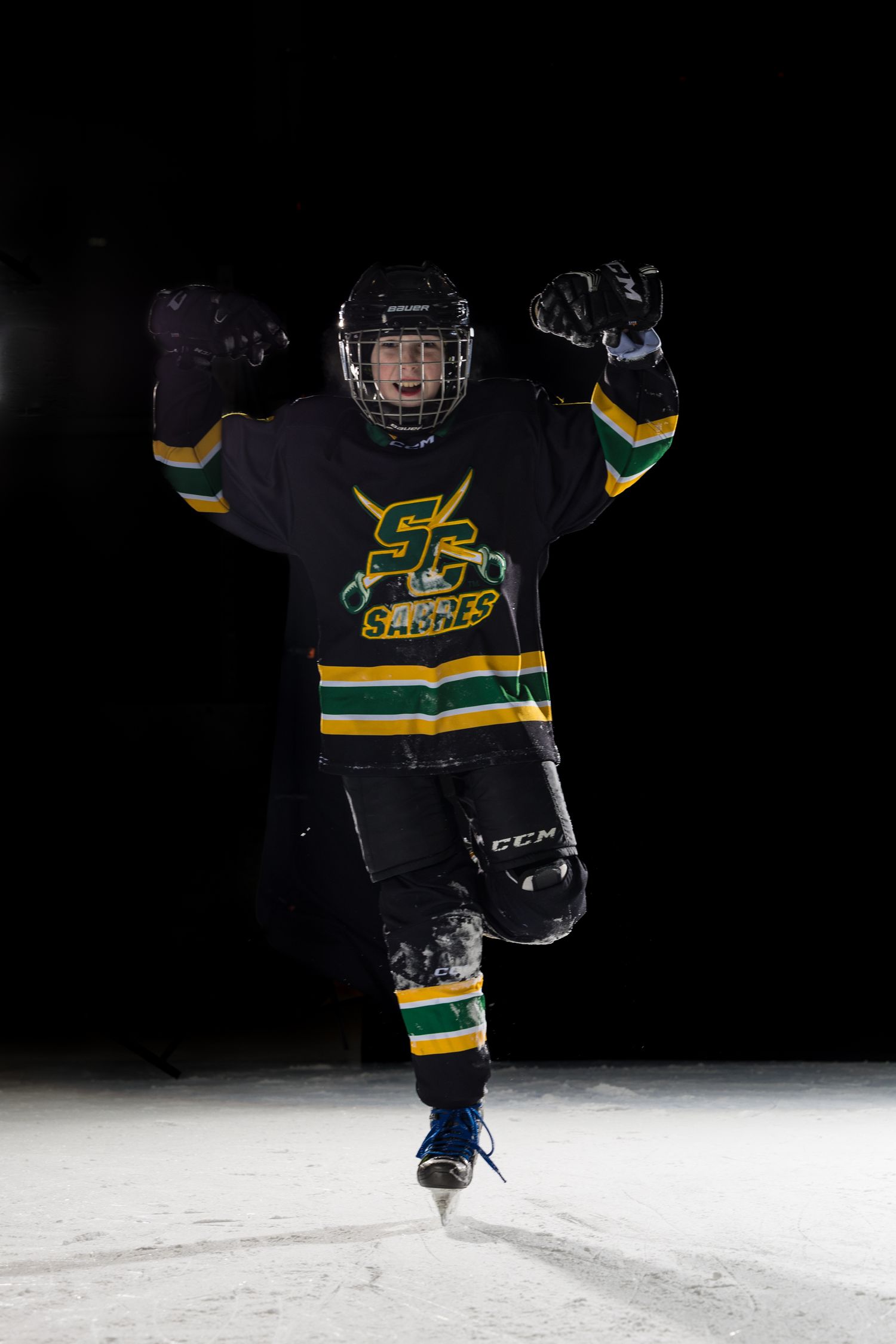 Stoney Creek Sabres Girls hockey player posing for a celly during on ice portrait session in Stoney Creek
