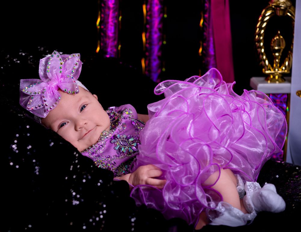 A group of photos showing a smiling baby wearing a purple tutu dress at a dance studio with purple lighting.