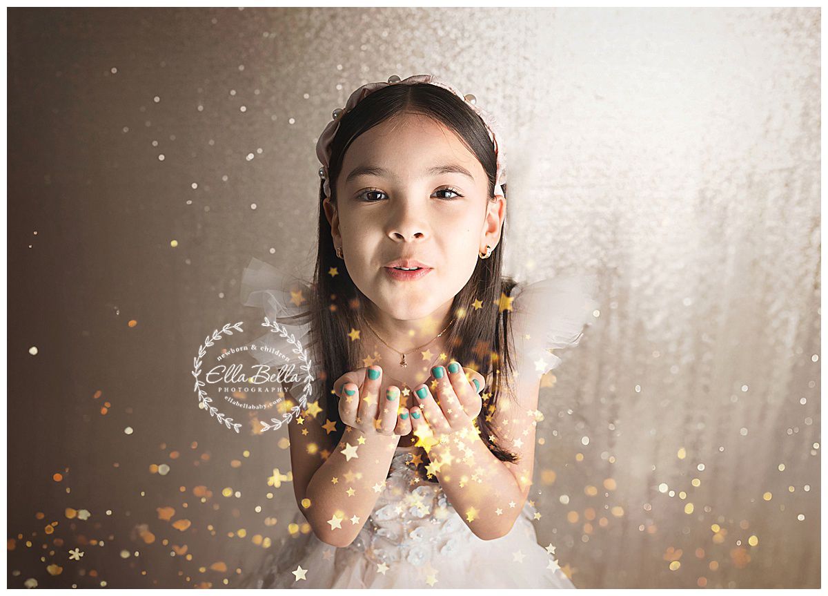 Portrait with glitter and sparkles against shimmering backdrop.