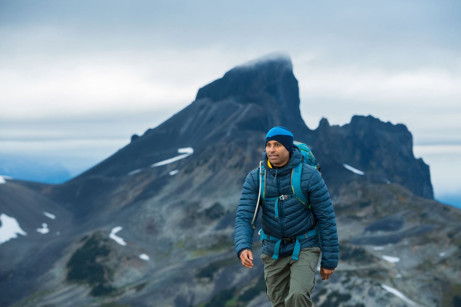 Hiker stands on mountain ridge with dramatic cloudy peak in background.
Photographer Ryan Robinson
Black Tusk