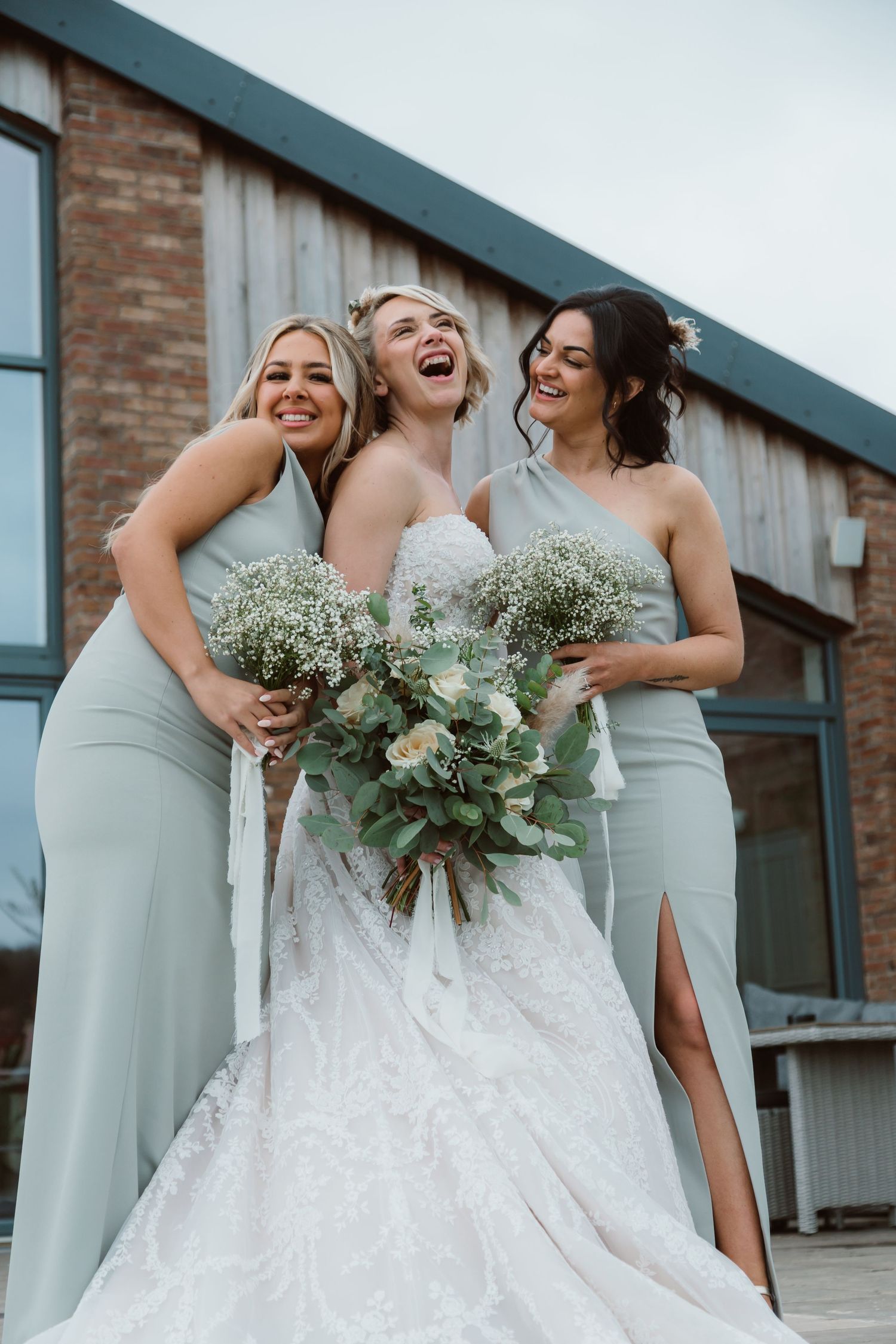 Bridesmaids in sage green dresses share a candid laughing moment with the bride. Photographer. Hull. East Yorkshire. Photography