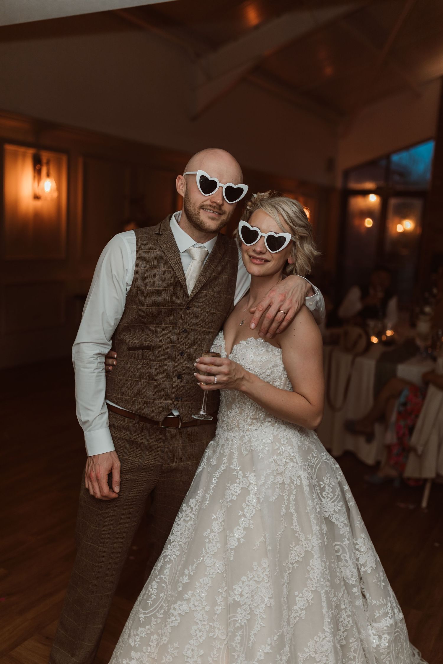 Wedding couple wearing heart-shaped sunglasses dance together at their reception. Photographer. Hull. East Yorkshire. Photography