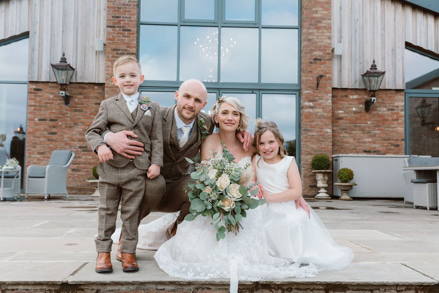 Modern brick and glass wedding venue exterior with newlyweds posing on the patio. Photographer. Hull. East Yorkshire. Photography