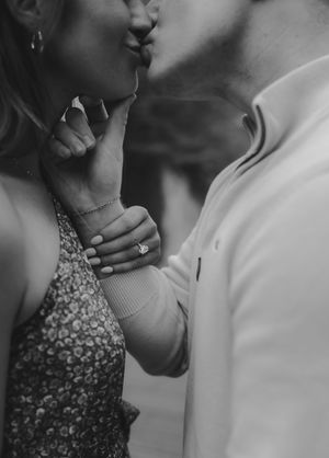 Black and white romantic couple portrait series showing intimate moments and gestures between partners during a photoshoot.
