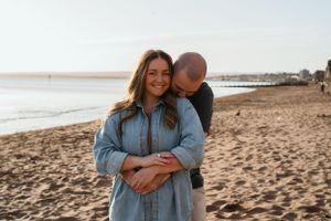 Couple snuggling at sunrise