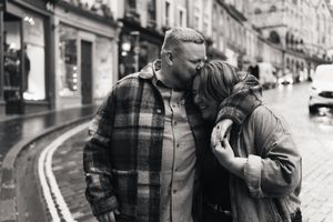 A black and white photo collage showing intimate romantic moments between couples on city streets.