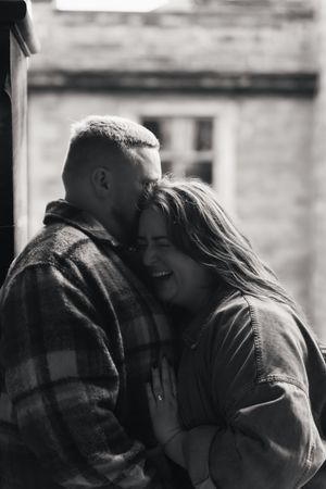 A black and white photo sequence shows a couple sharing an intimate kiss in progressive frames.