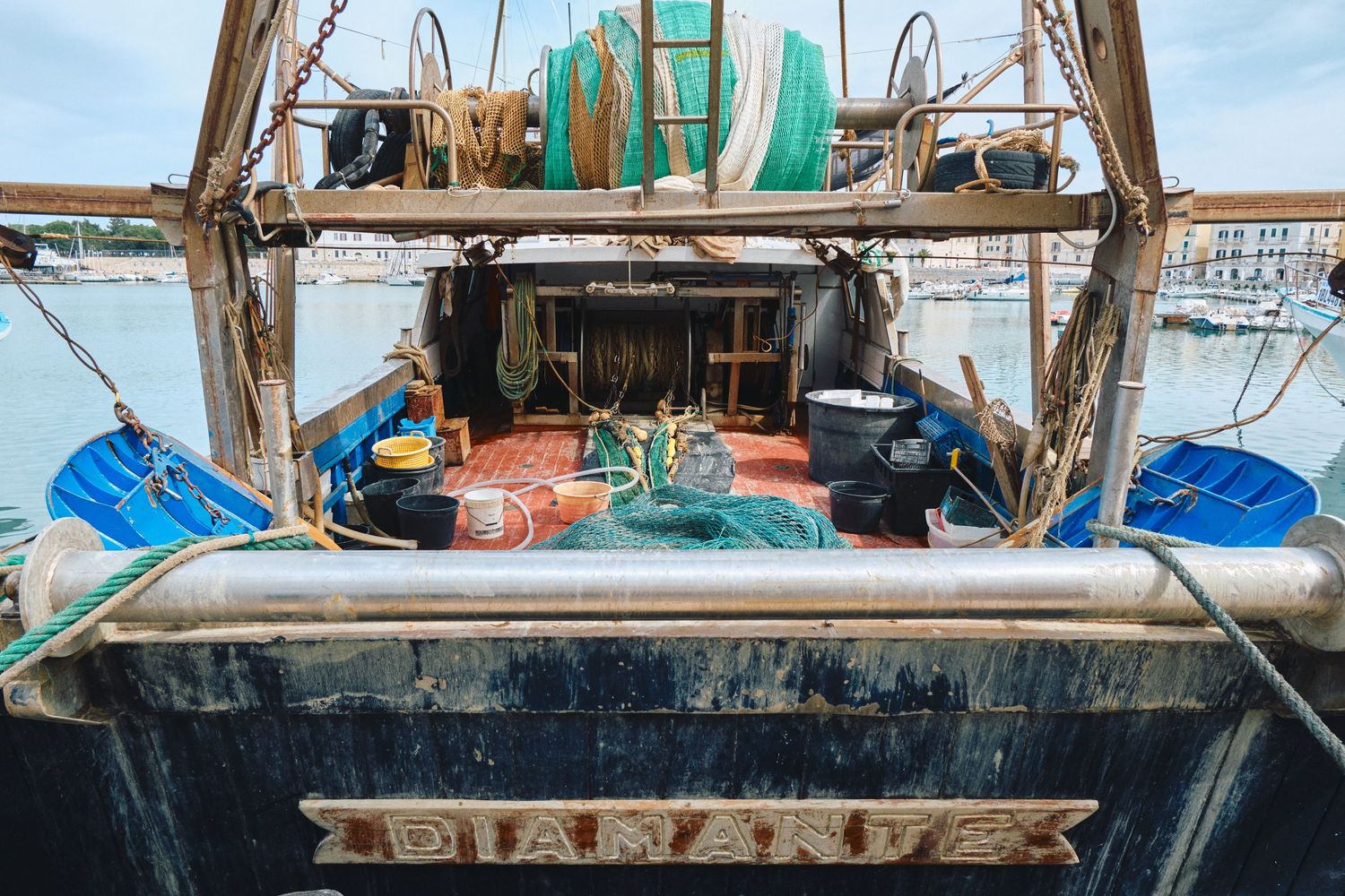 Fishing equipment and nets stored on the deck of a commercial fishing boat.