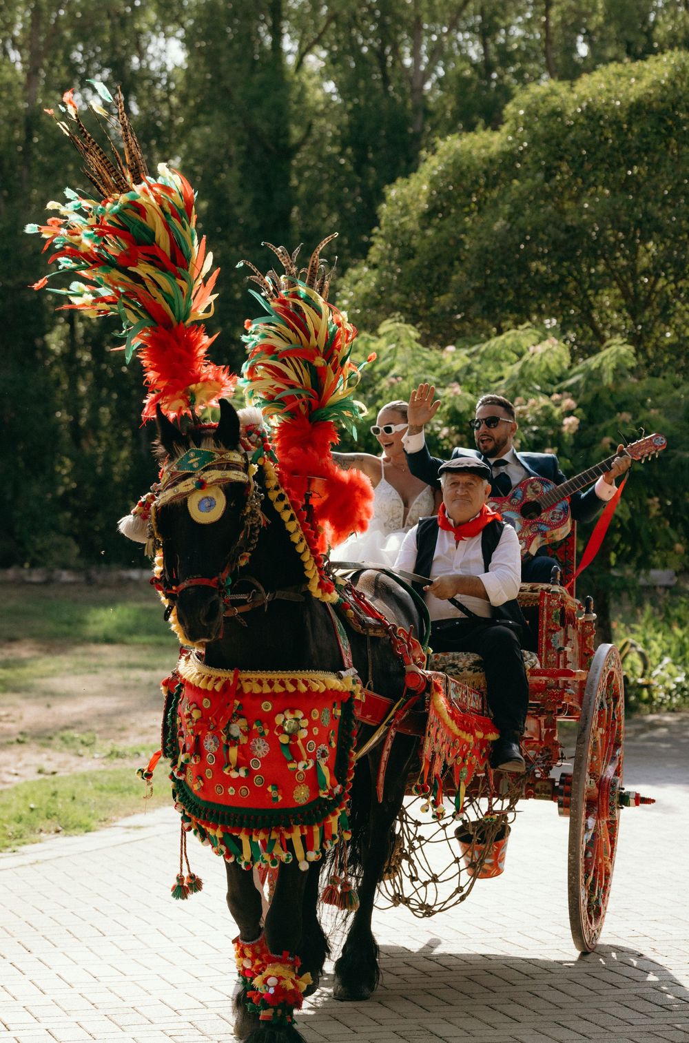 Decorative horse-drawn carriage adorned with vibrant red flowers and traditional ornaments.