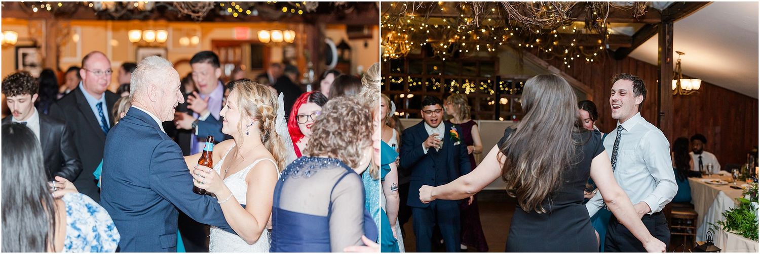 Wedding reception guests dance and celebrate on a warmly lit dance floor with hanging decorative lights.