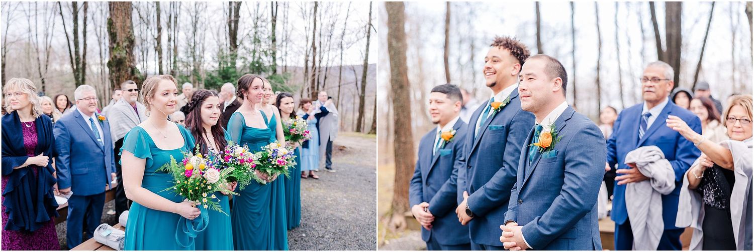 Wedding party members in blue and teal attire react joyfully during outdoor forest ceremony.