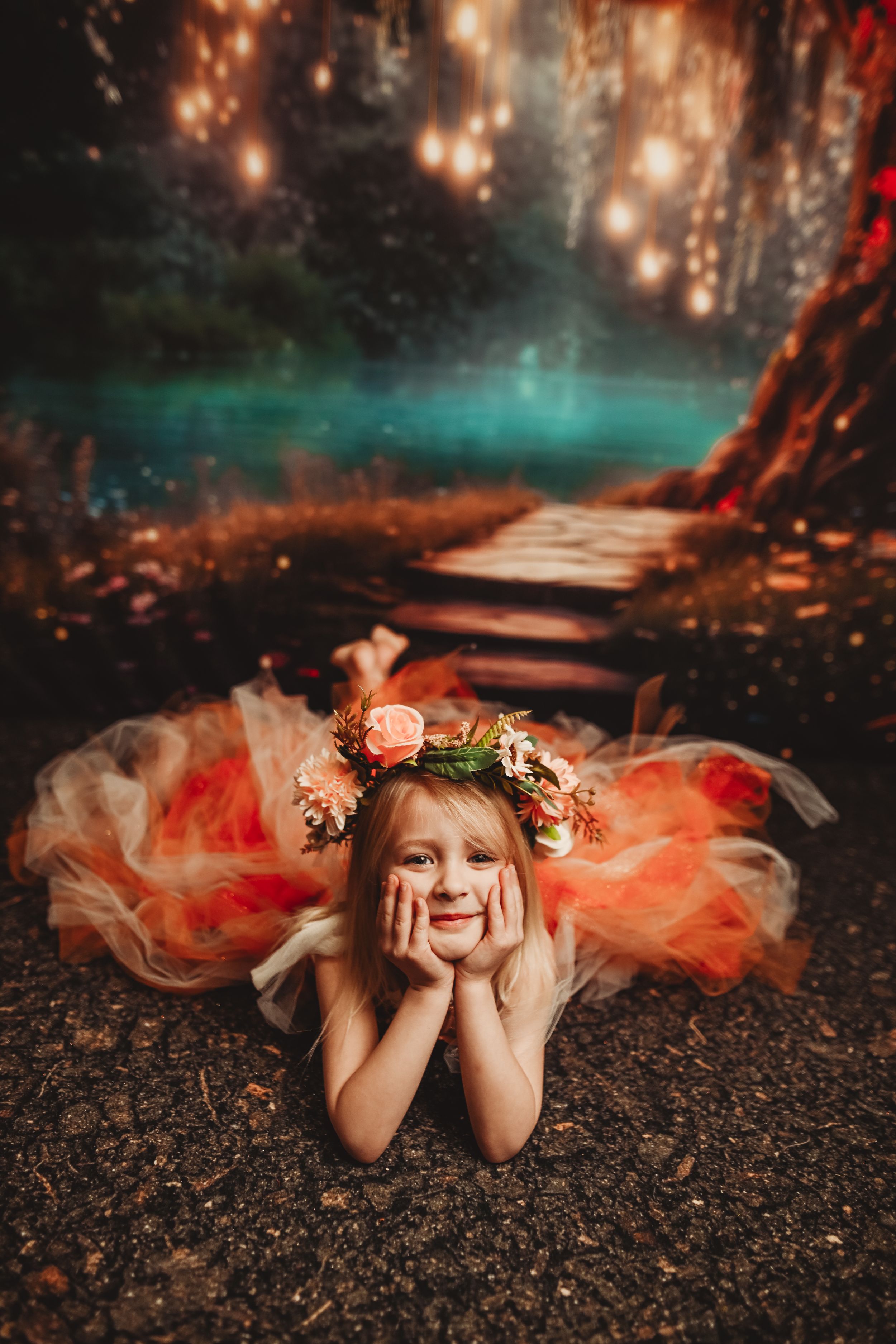 Dreamy forest photography with flower crown and peach tulle dress laying on autumn ground.