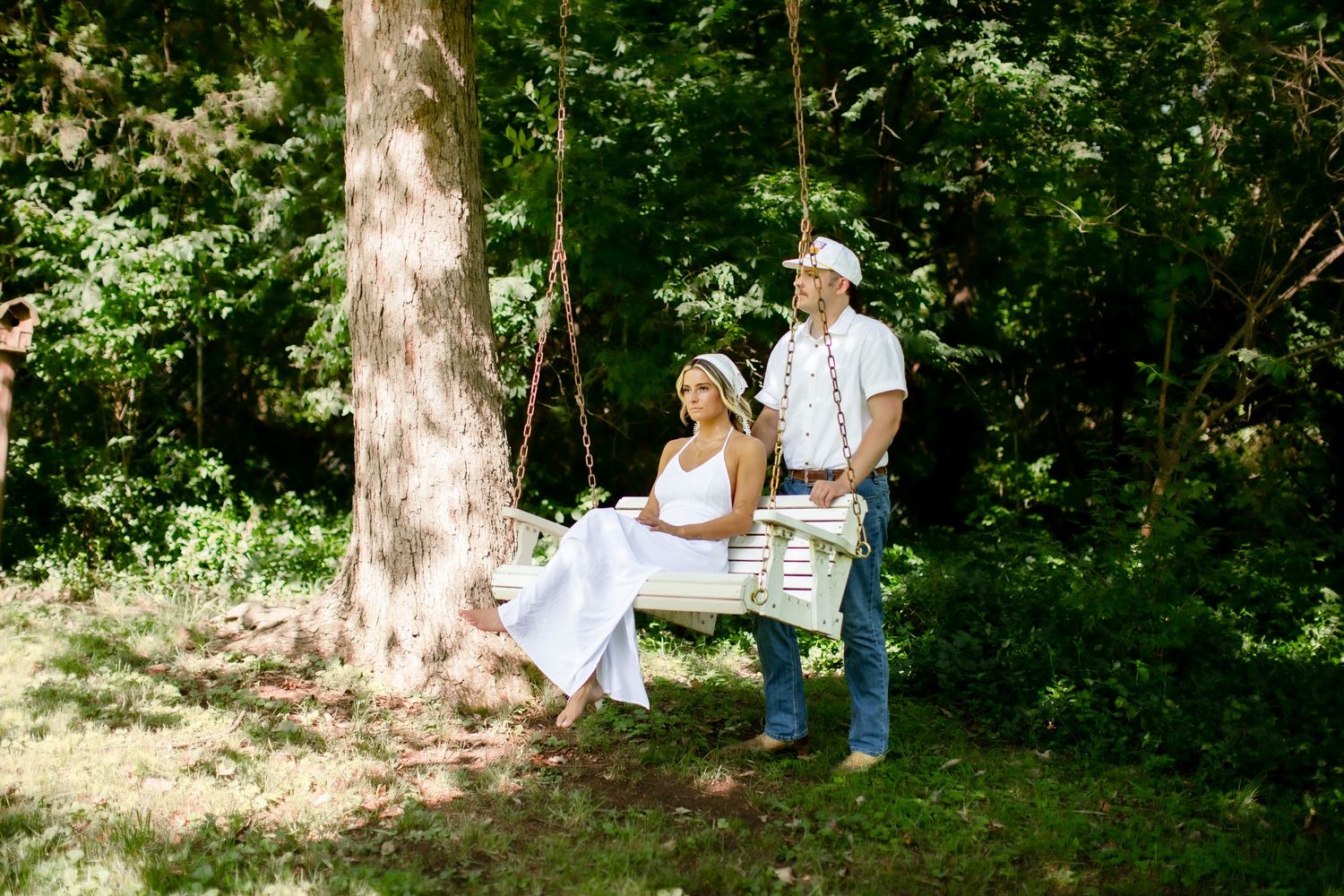 Couple embraces during golden hour sunset in natural outdoor setting.