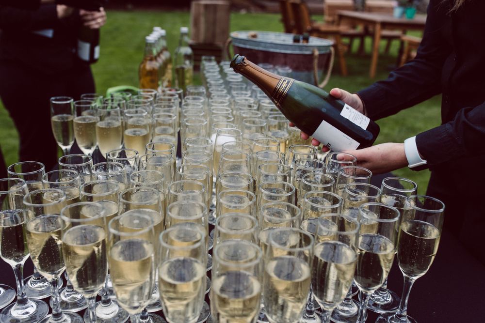 Multiple champagne glasses arranged for a wedding reception toast.