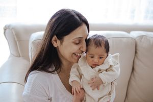 A collection of intimate family moments showing parent and baby bonding on a light colored couch.