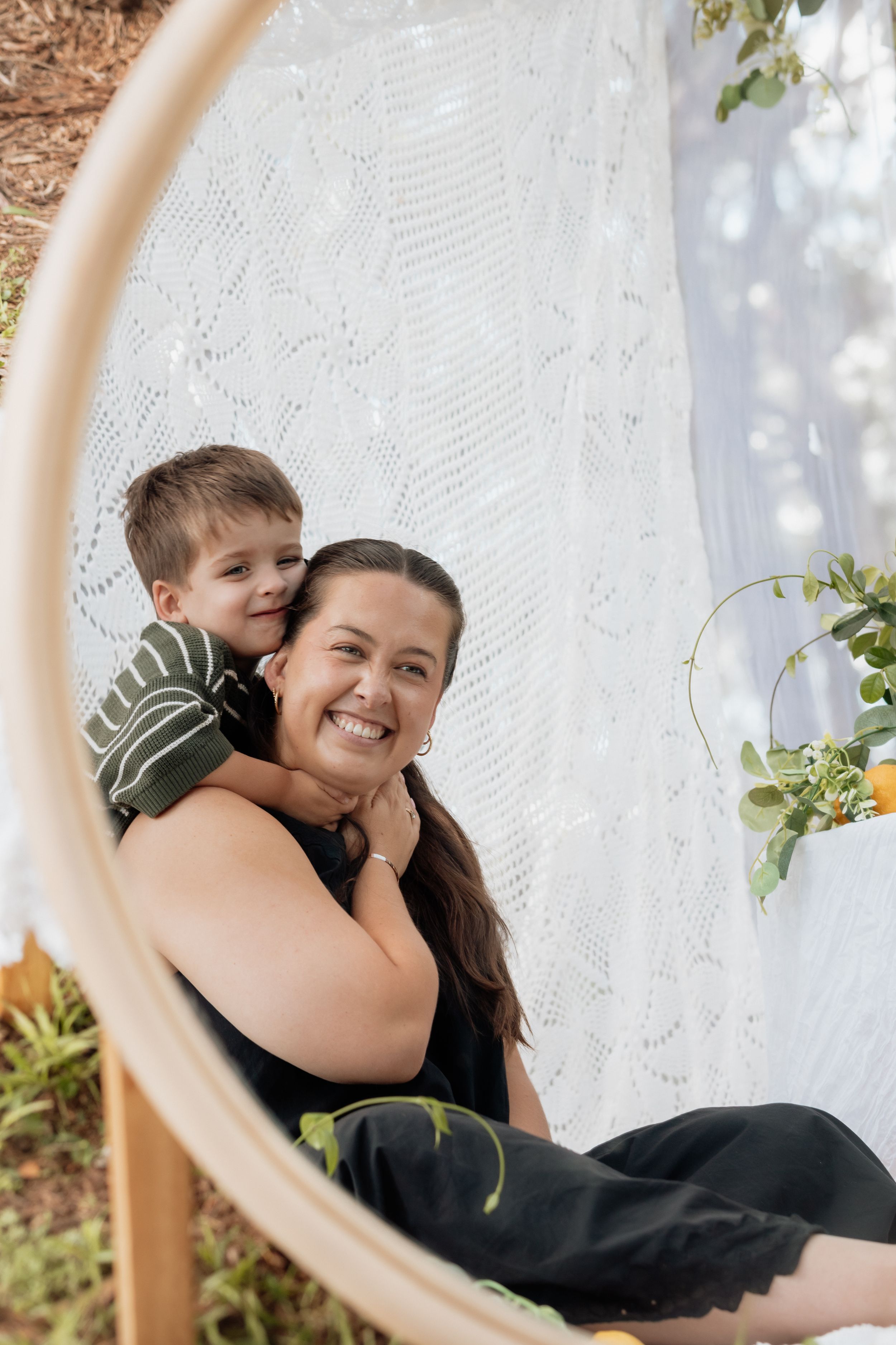 A heartwarming moment captured through a series of candid shots in front of white lace curtains outdoors.