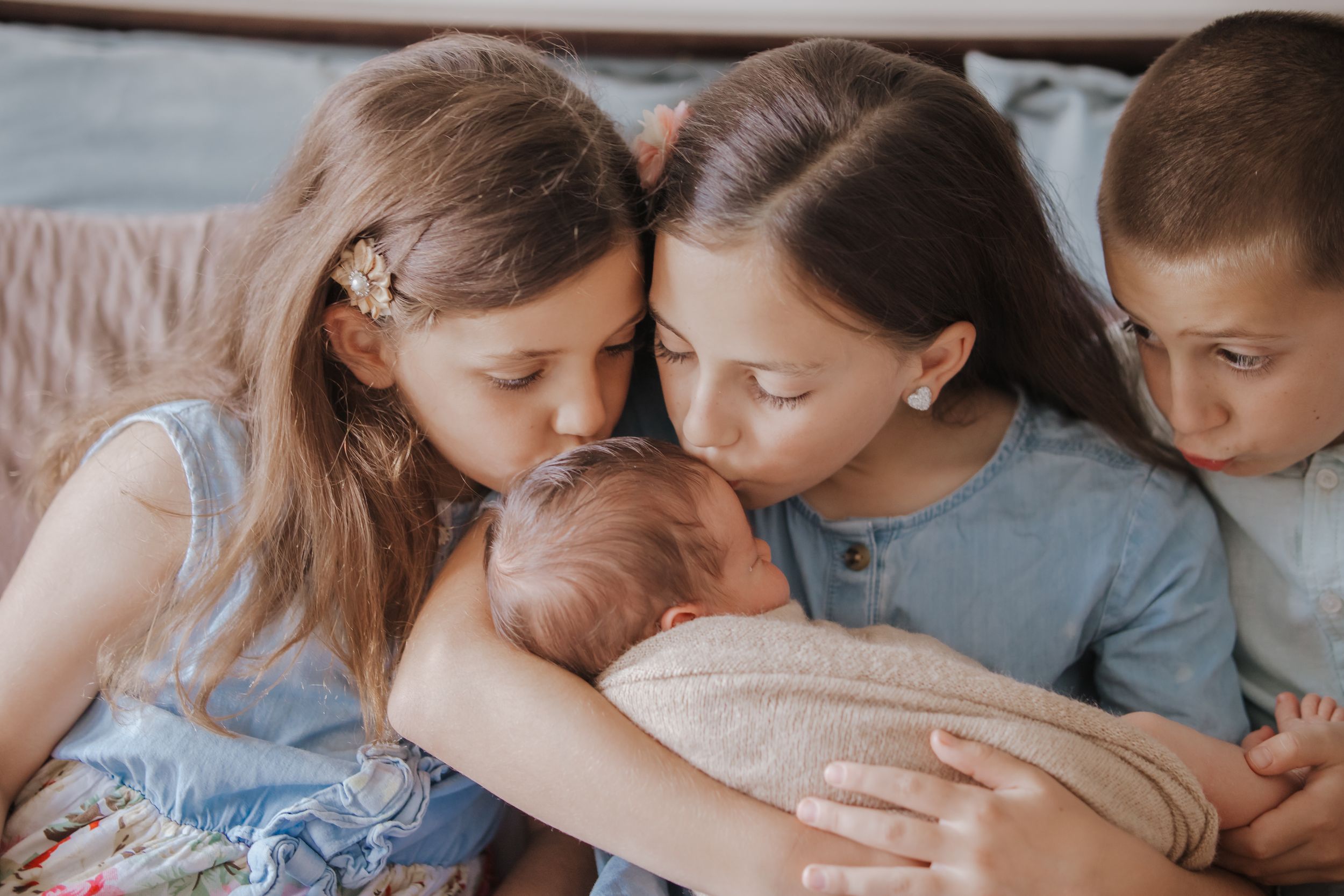 A collage of intimate family moments showing hands embracing and holding each other in soft, muted tones.