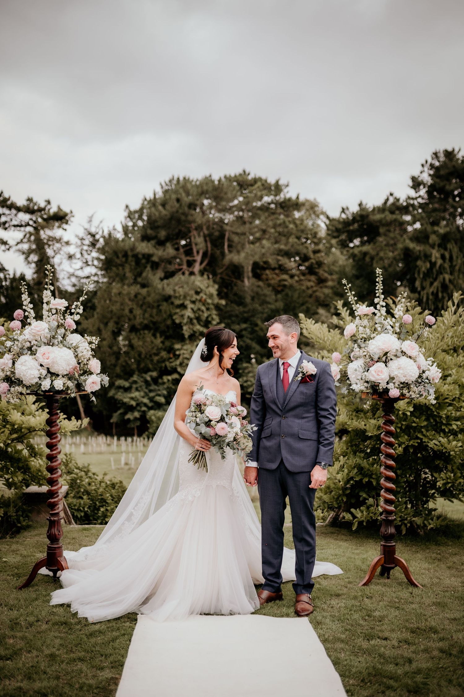 bride and groom posing for a photo on the grand staircase at highfield house