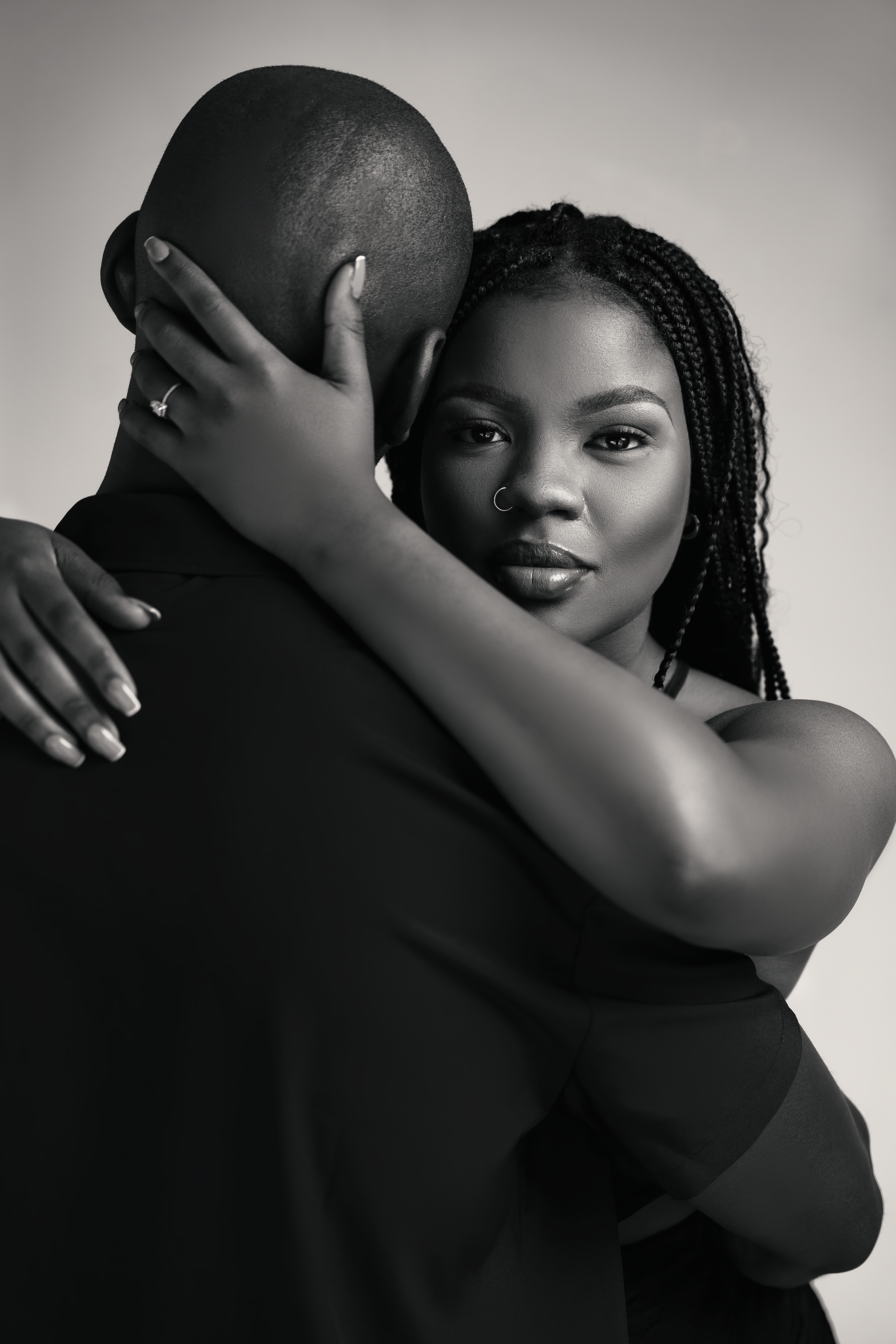 Romantic black and white portrait of couple embracing in intimate pose.