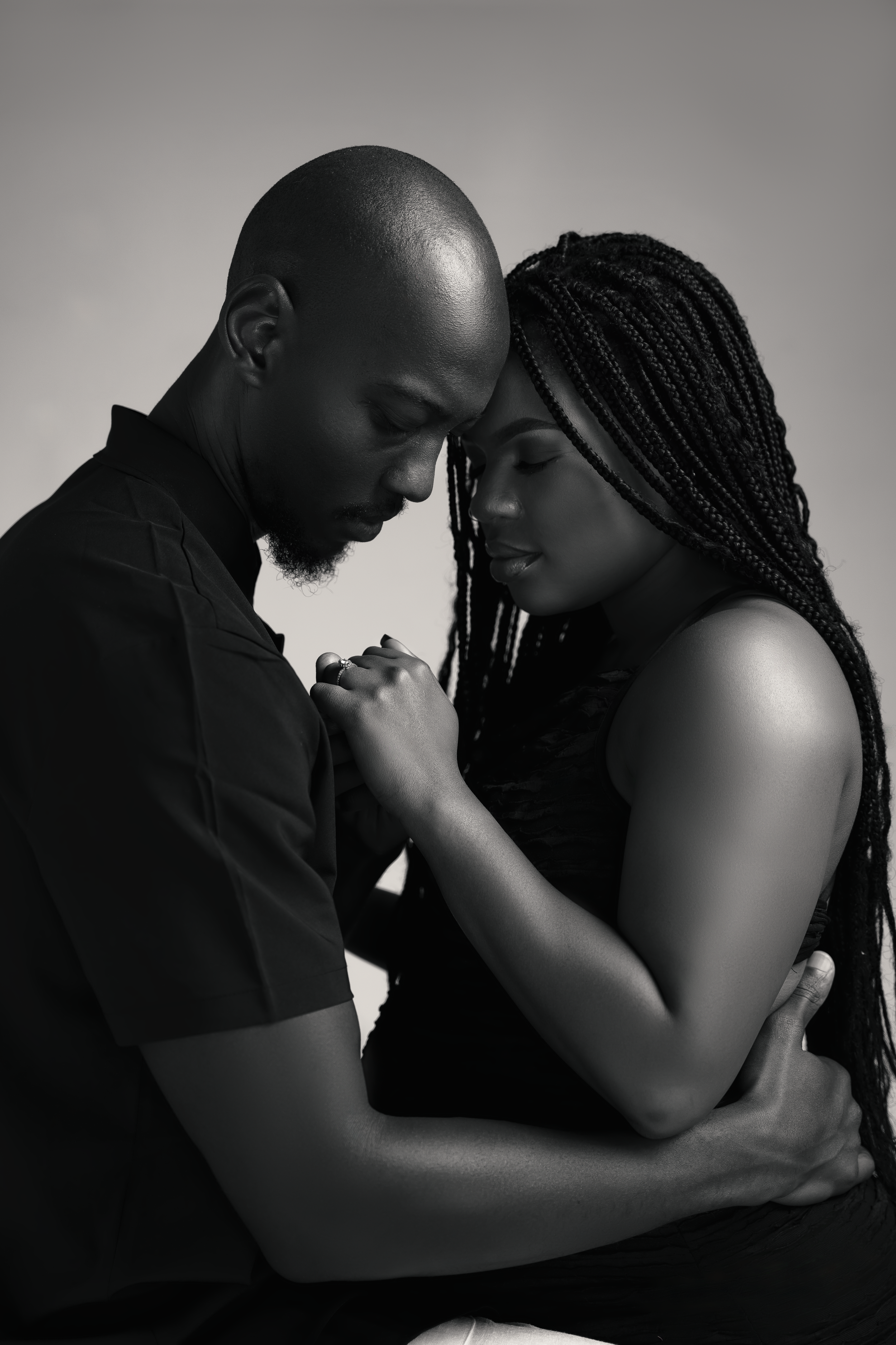 Intimate black and white portrait of couple in tender moment.