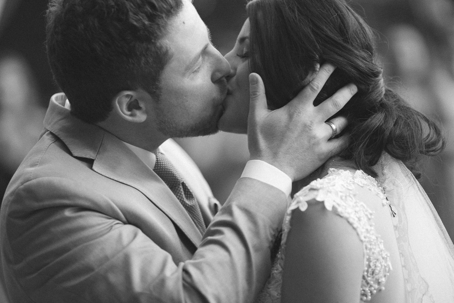 Intimate black and white portrait of romantic wedding moment.