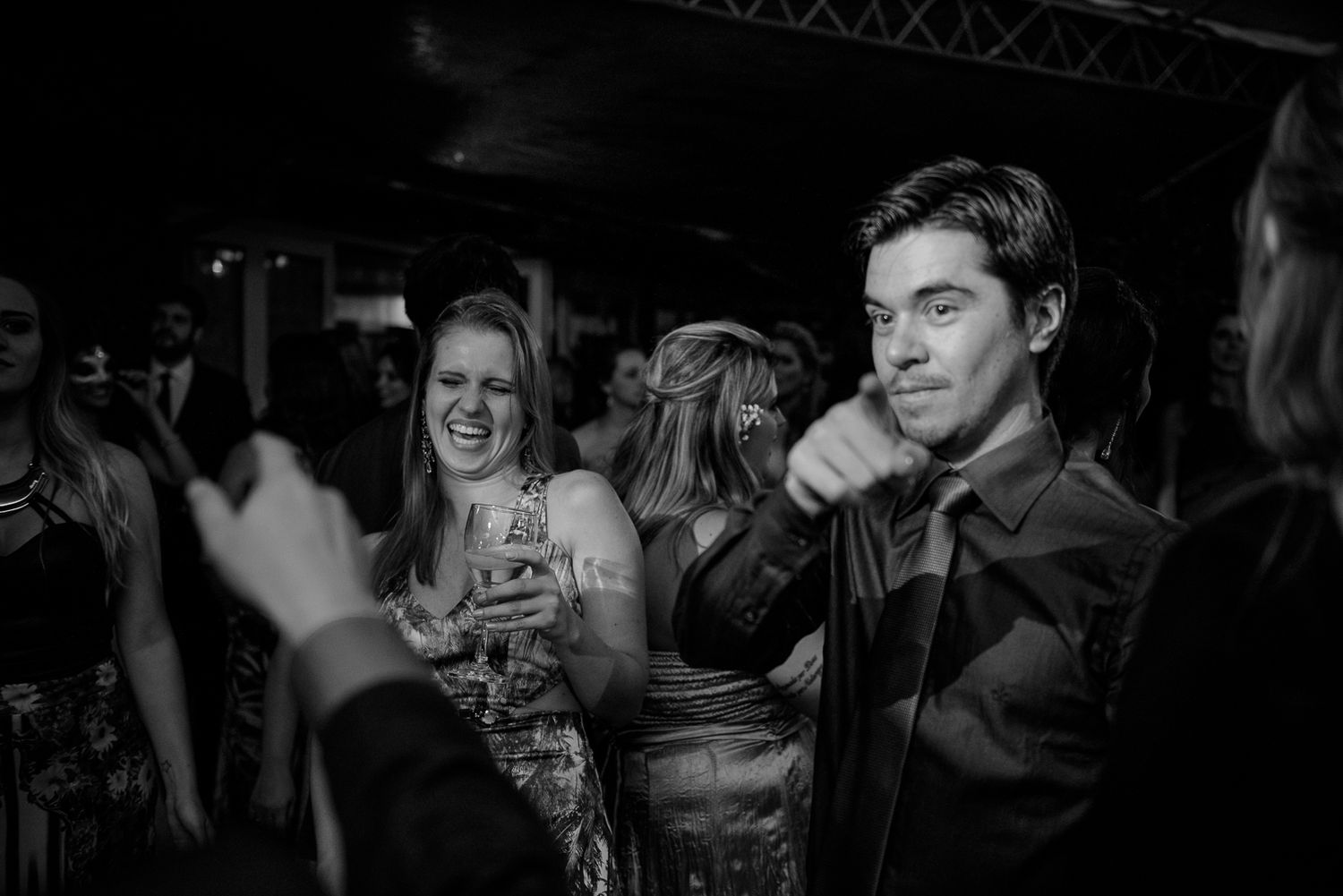 Party guests enjoying themselves on a lively dance floor under mood lighting.