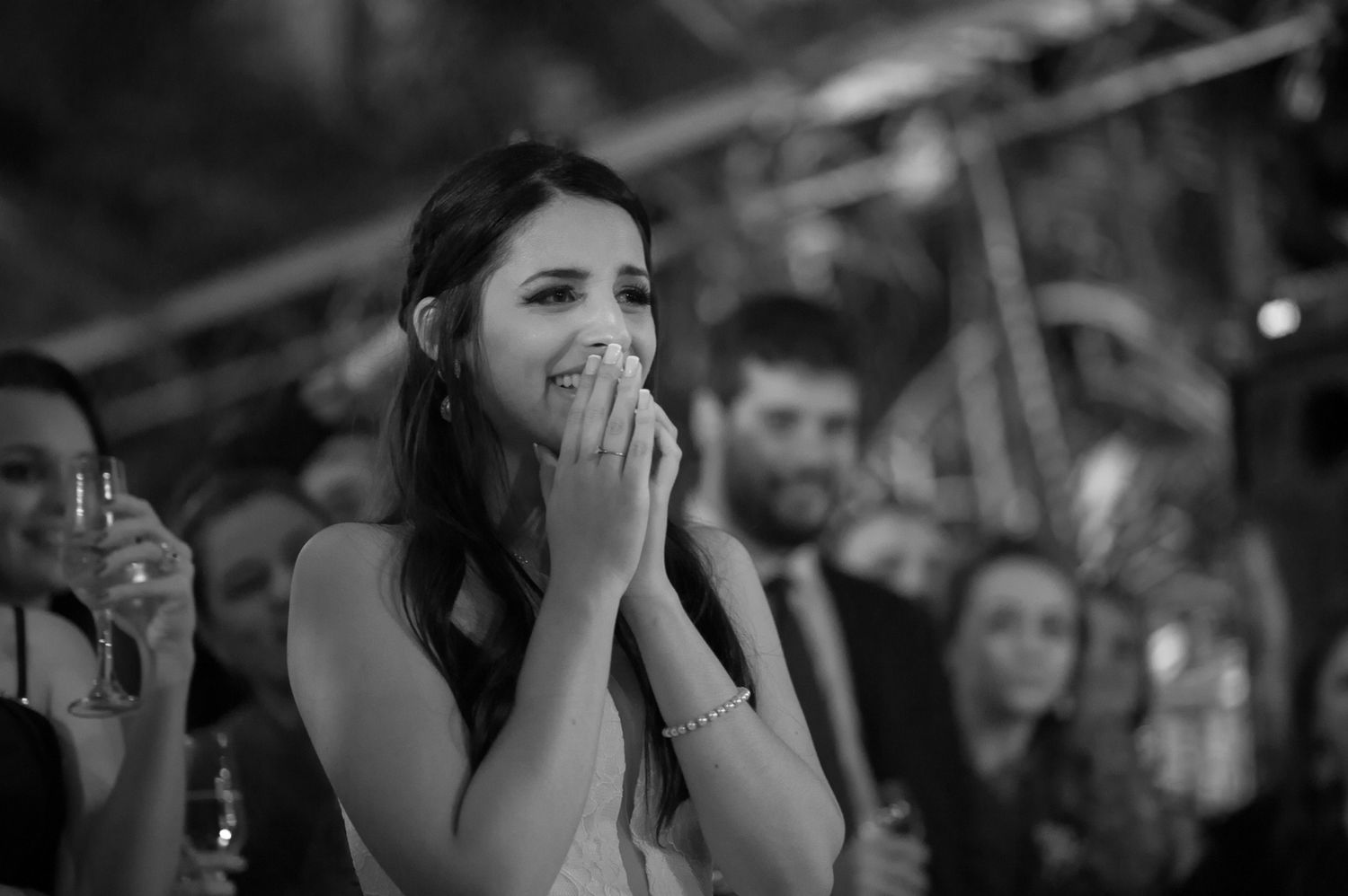 A candid emotional moment captured during a wedding reception celebration.