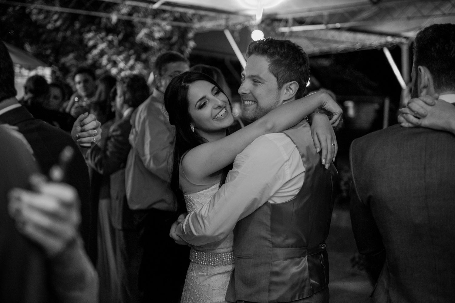 A couple embraces during an intimate dance at their reception.